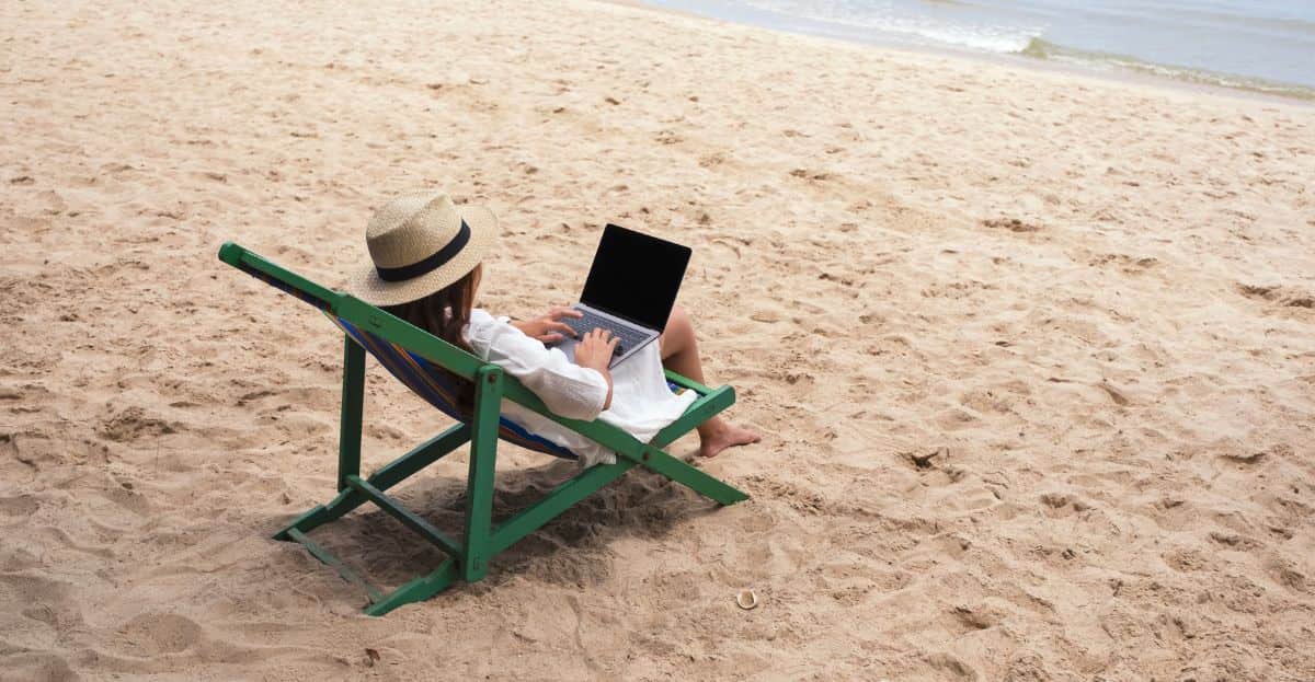 woman on beach with computer