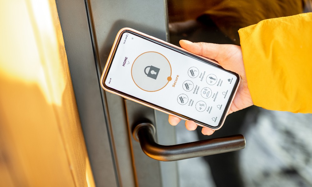 Person locking vacation home with smart phone